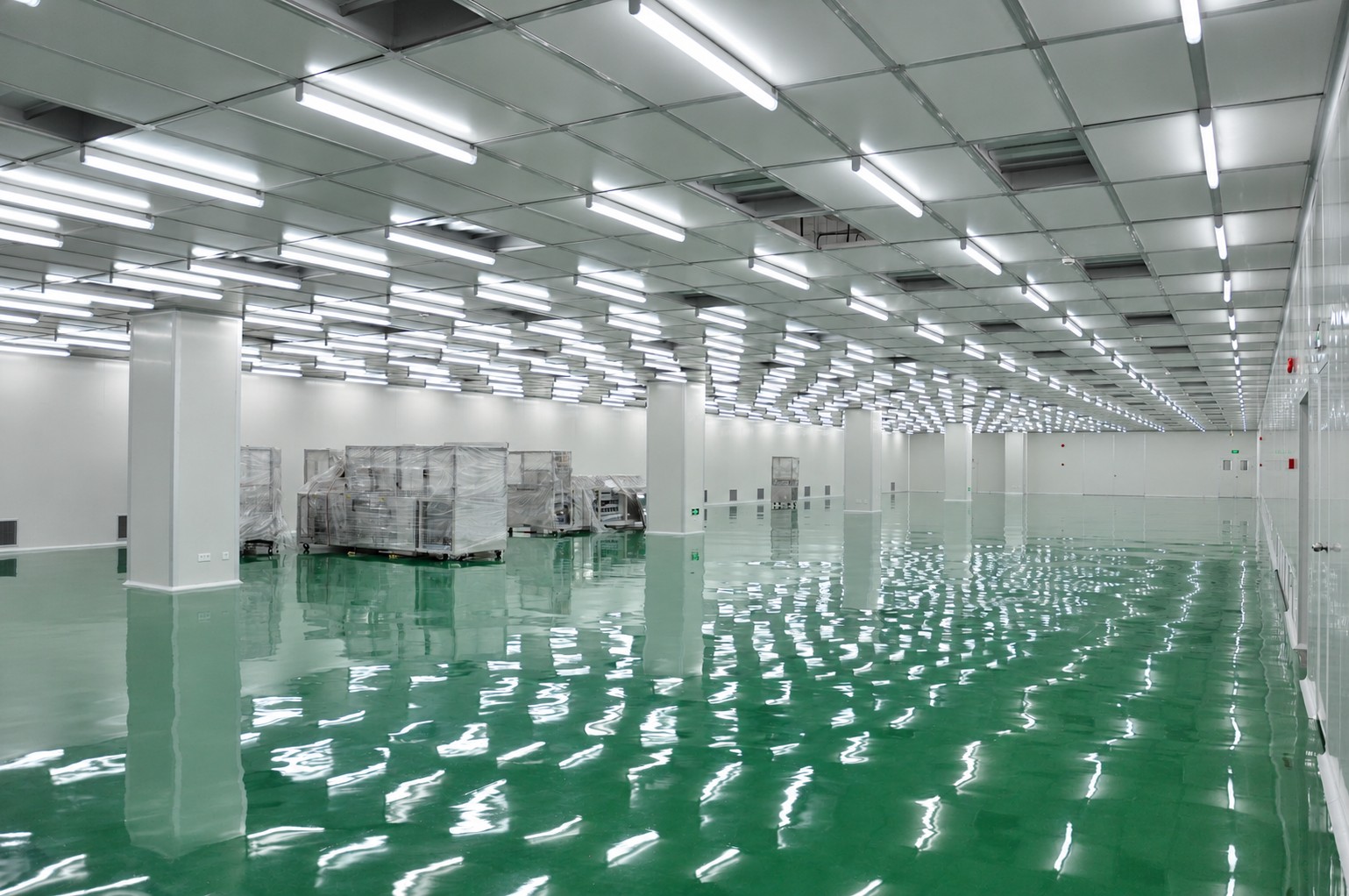 Display-manufacturing room with panel walls, observation glazing and an organised ceiling grid