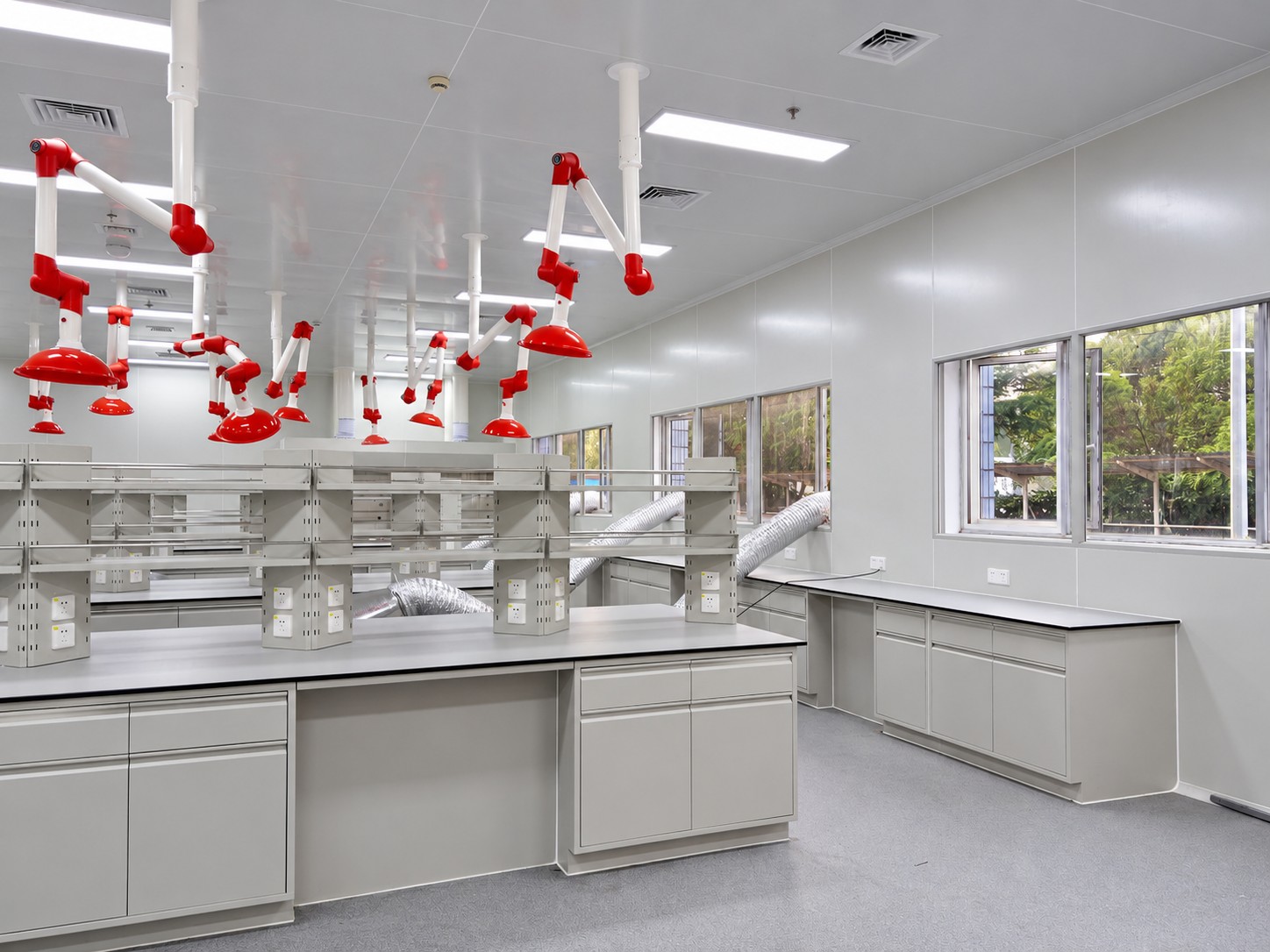 Laboratory benches with extract arms, glazed partitions and ceiling service interfaces