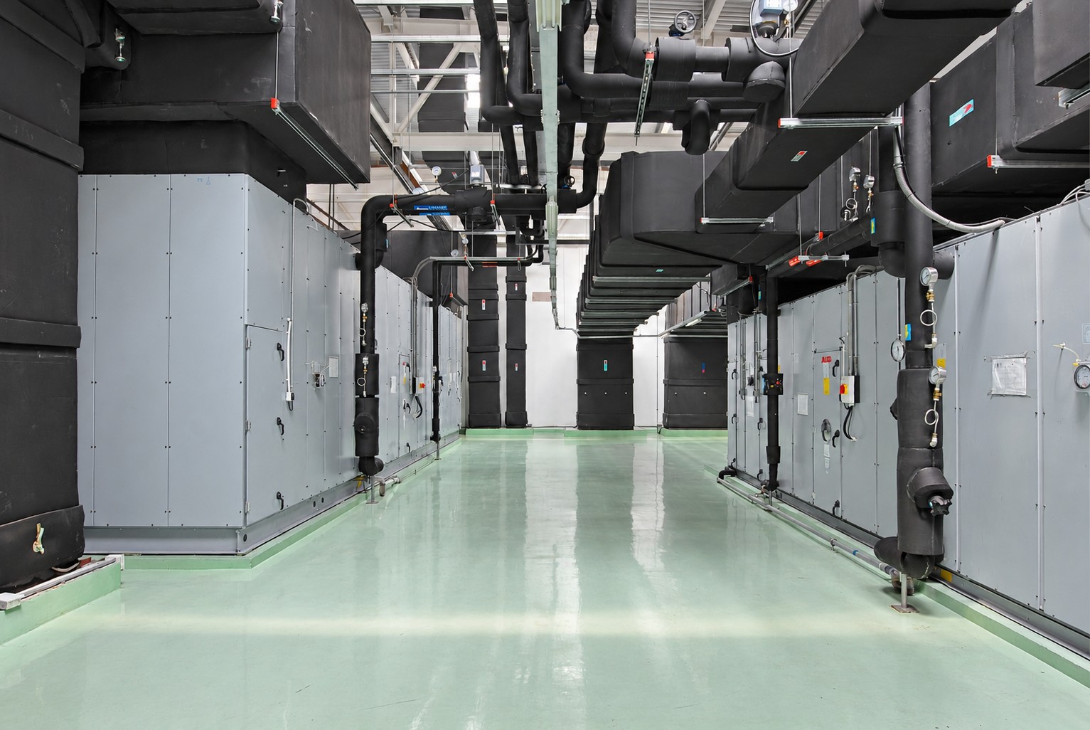 Mechanical-services corridor with air-handling equipment, insulated ducts and pipework