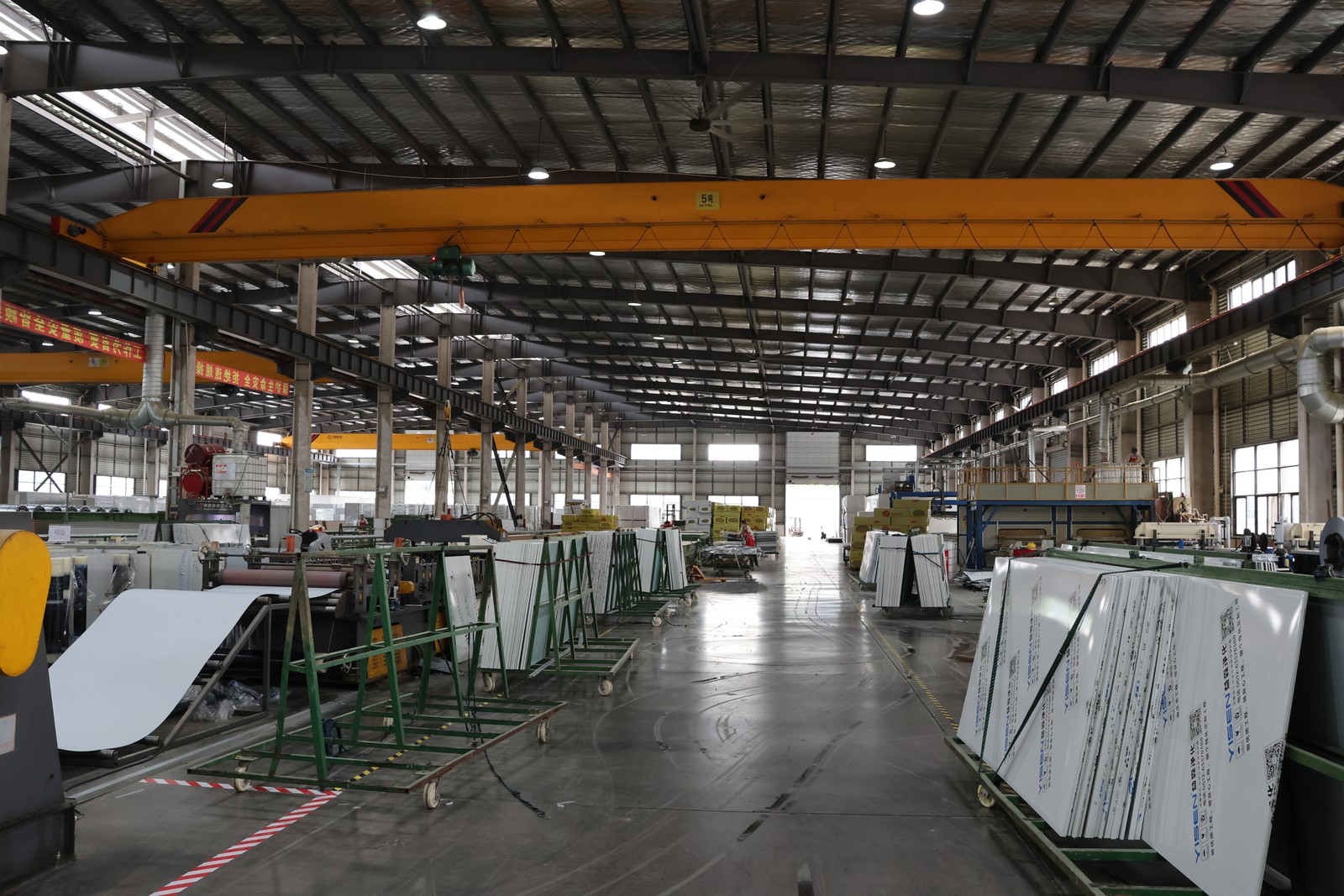Panel materials on racks beside manufacturing equipment