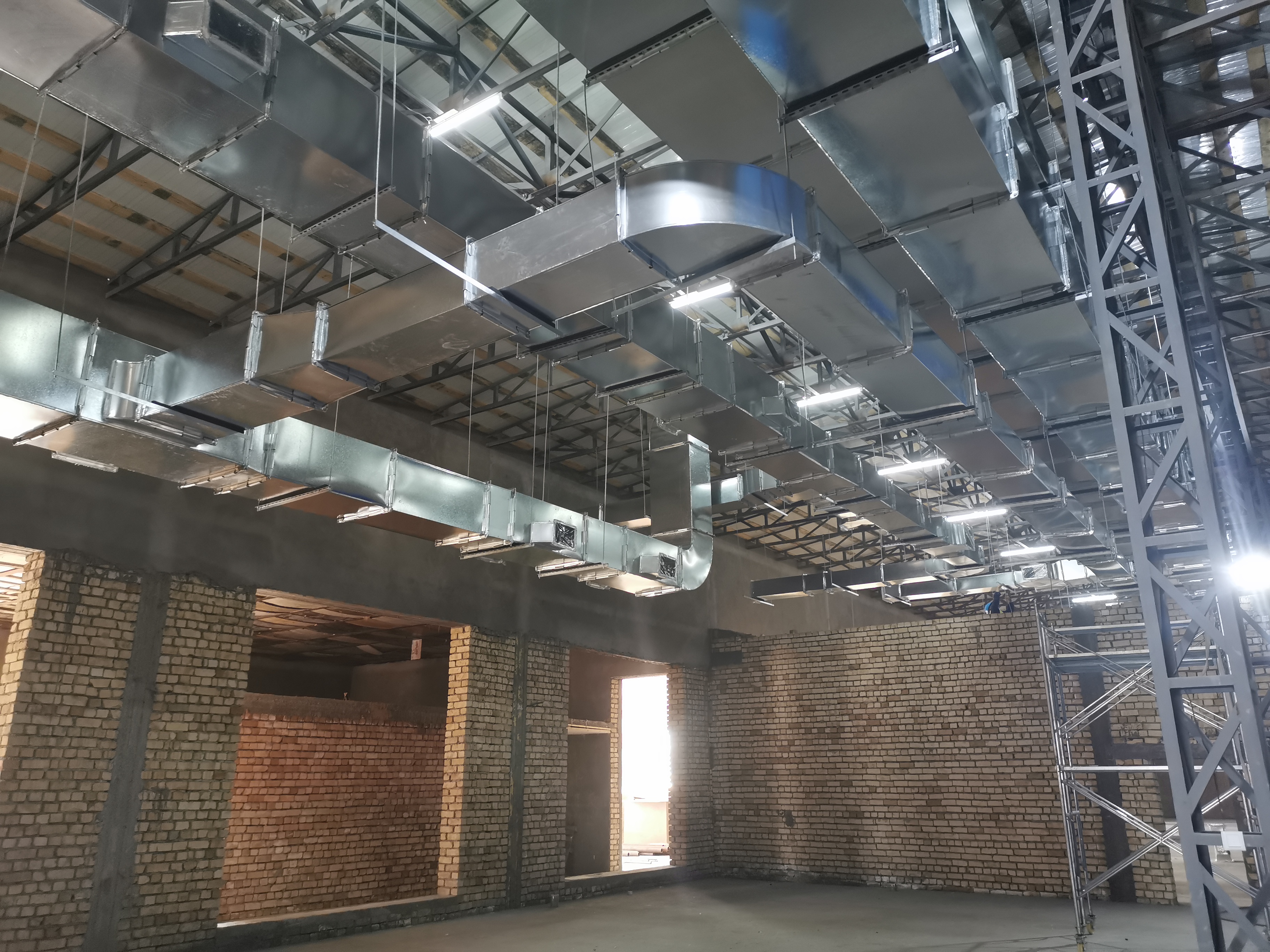 Rectangular HVAC ducts suspended inside a building under construction