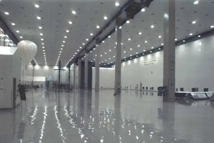 Large enclosed clean work area with high ceiling and wall panels