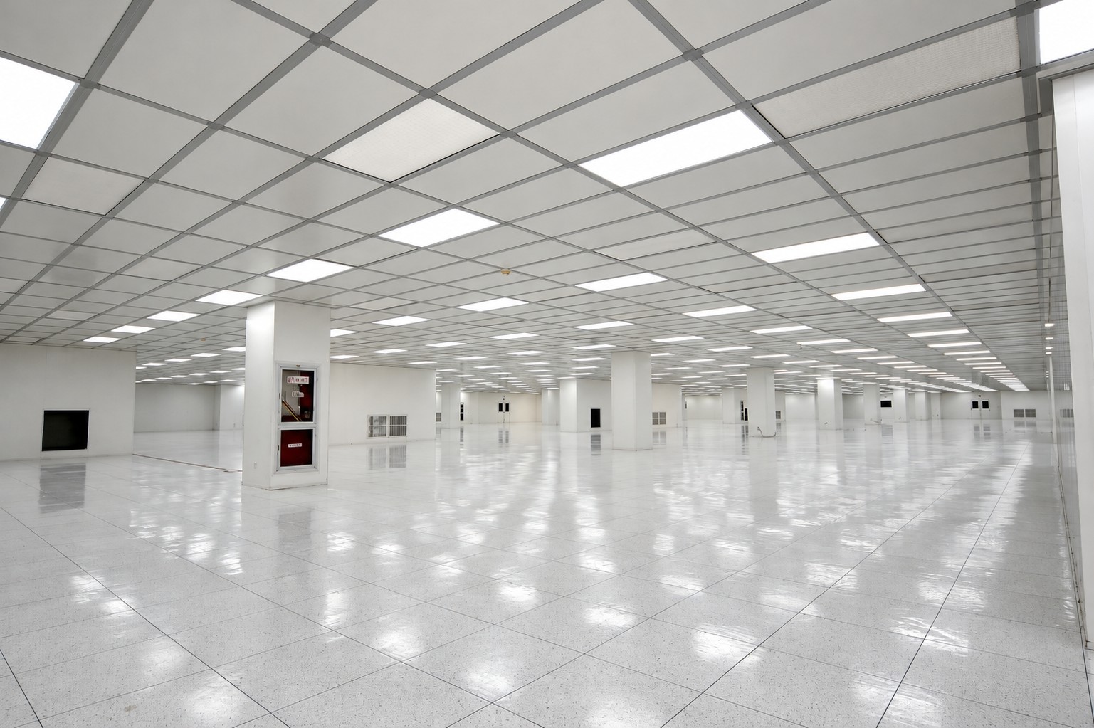 Panel-lined display-manufacturing room with coordinated ceiling lighting and room access