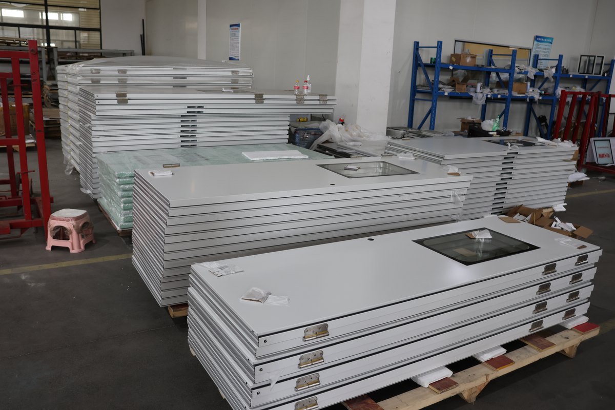 White door leaves with vision windows prepared on pallets