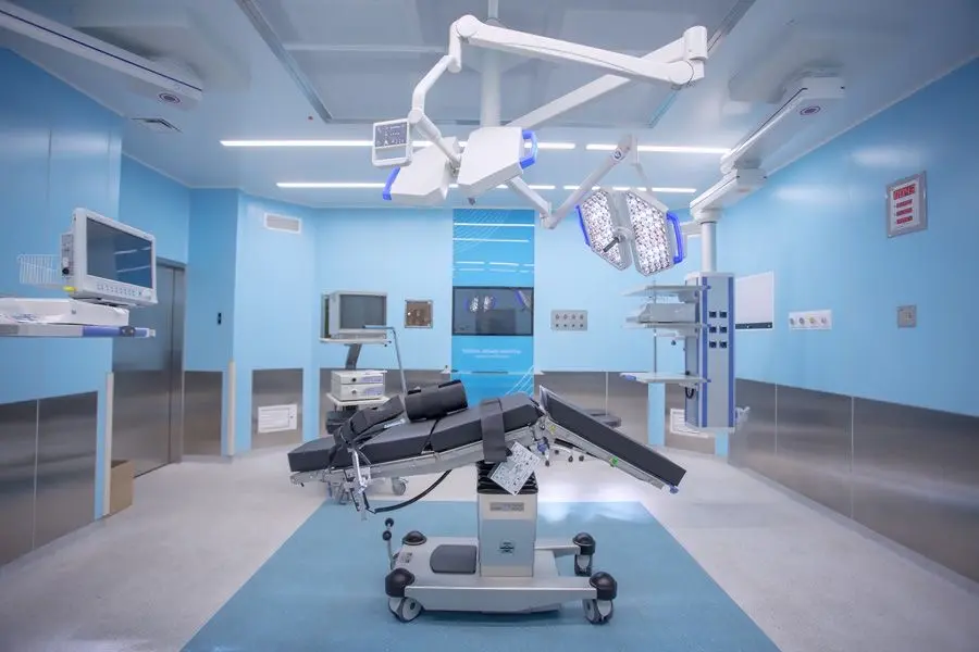 Operating room with surgical lights and operating table